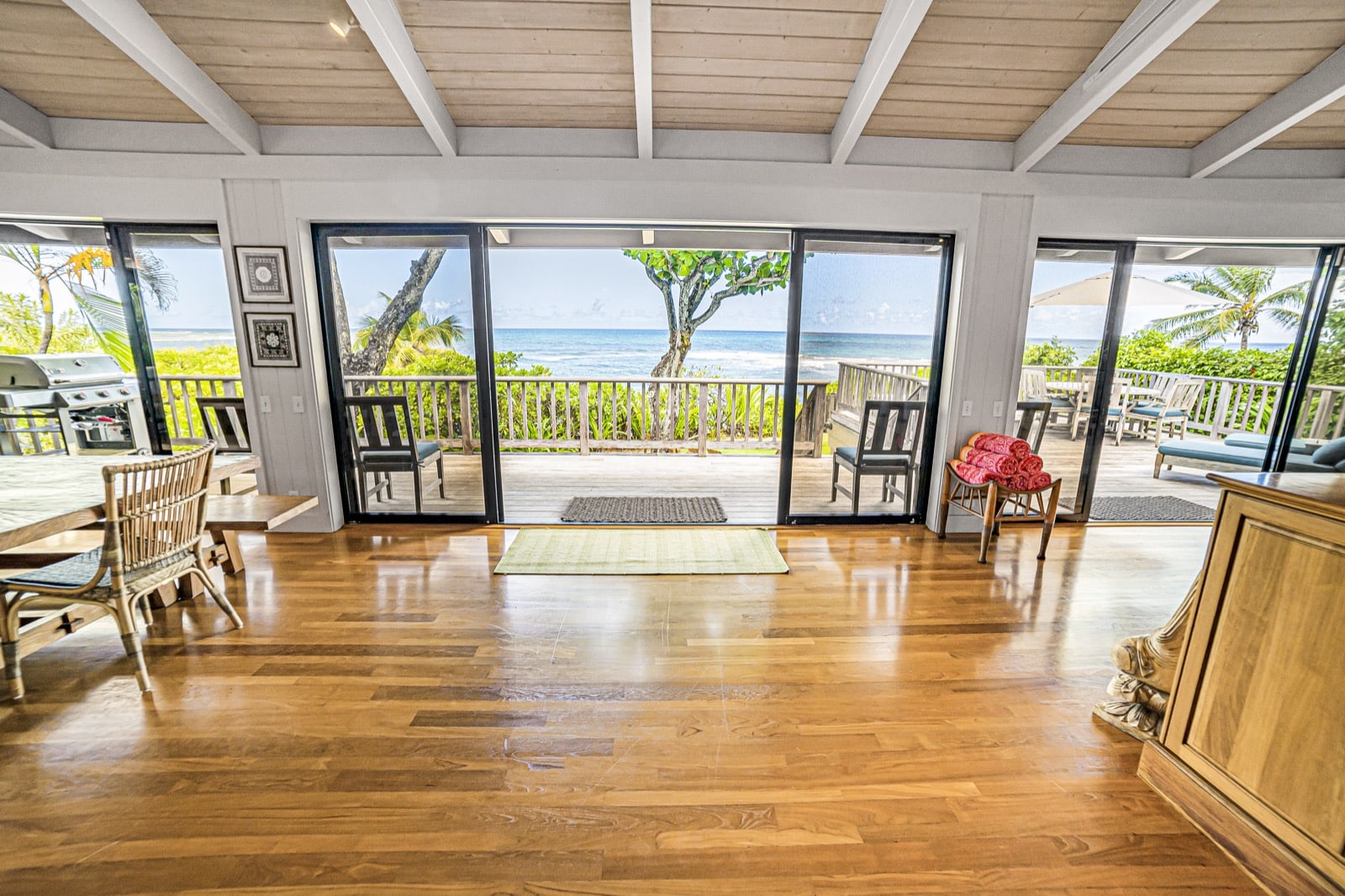Living room and sliding glass doors looking out toward the ocean.